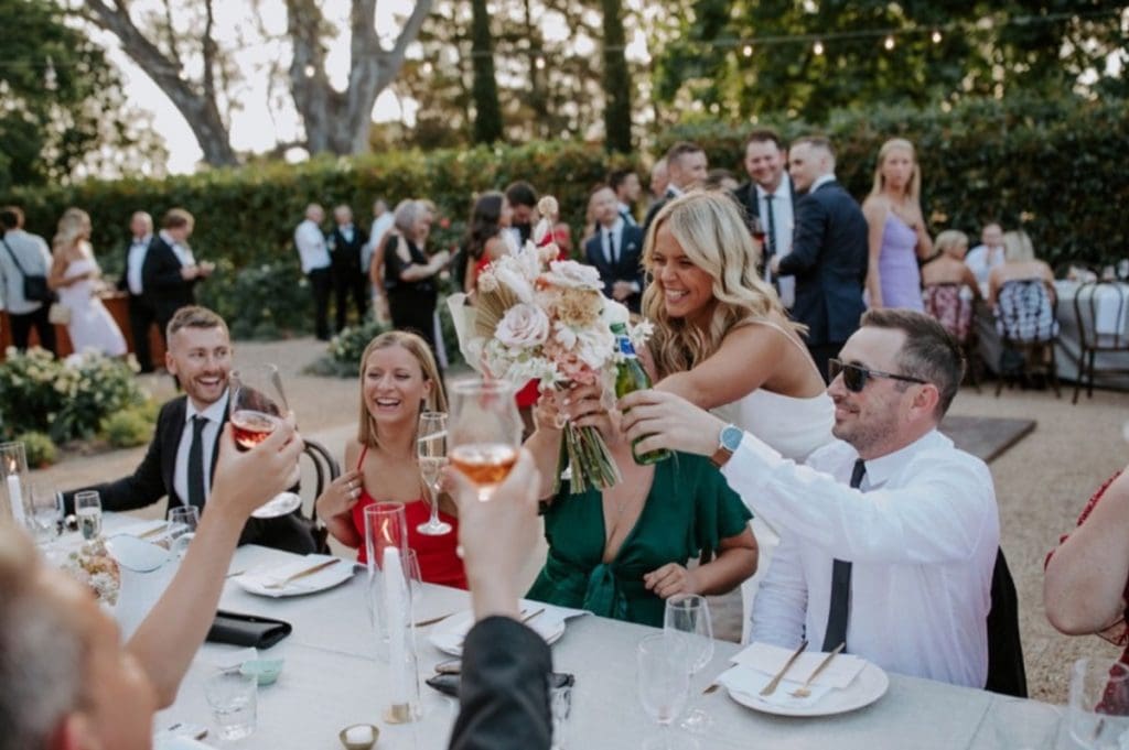 Bide And Guests Raising Glasses To Celebrate A Wedding At Euroa Butter Factory