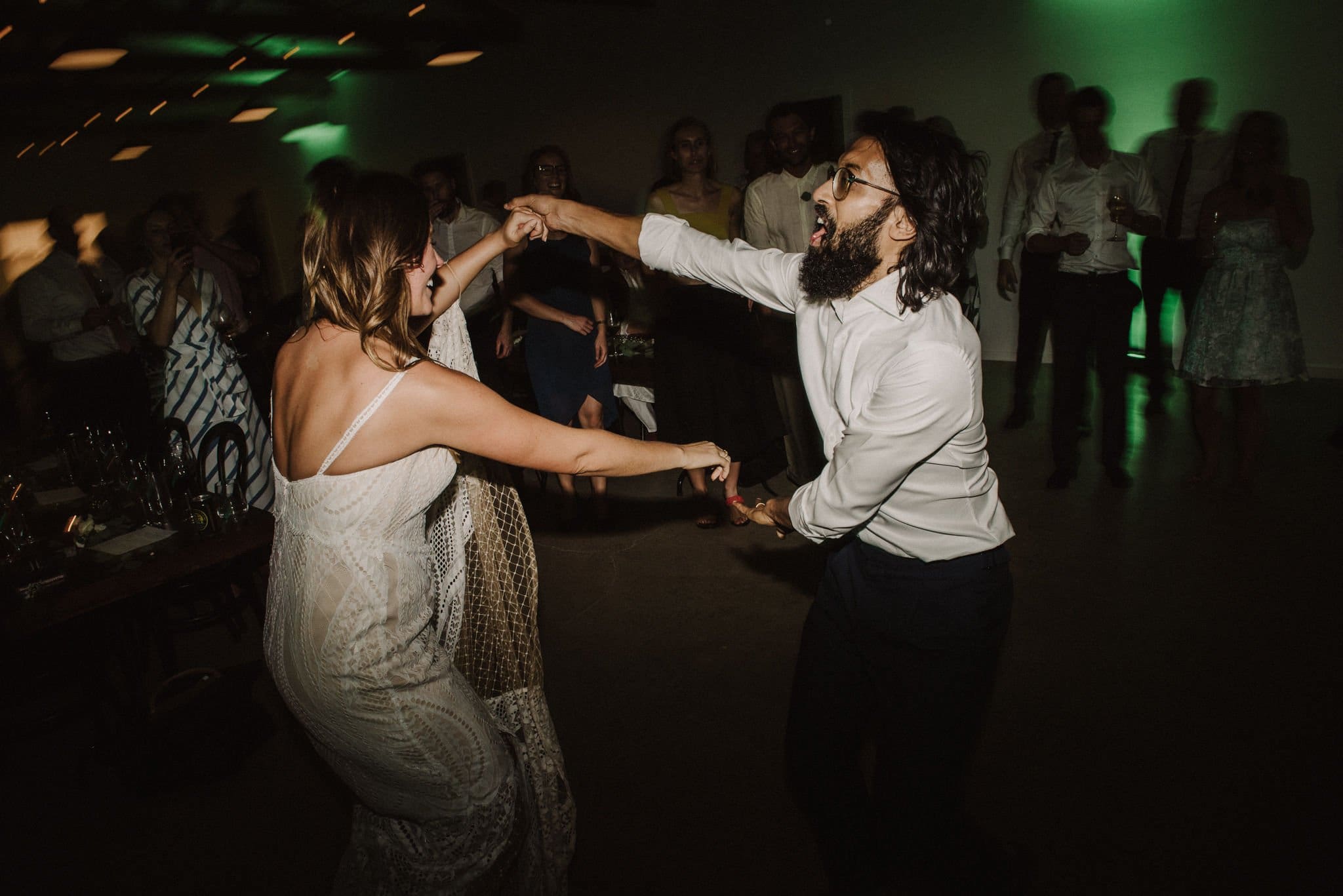 Bride And Groom Dancing With Friends And Family Circled Around Them