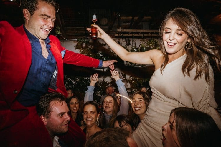 Married Couple Dance On Guests' Shoulders At Glasshaus Inside Cocktail Wedding