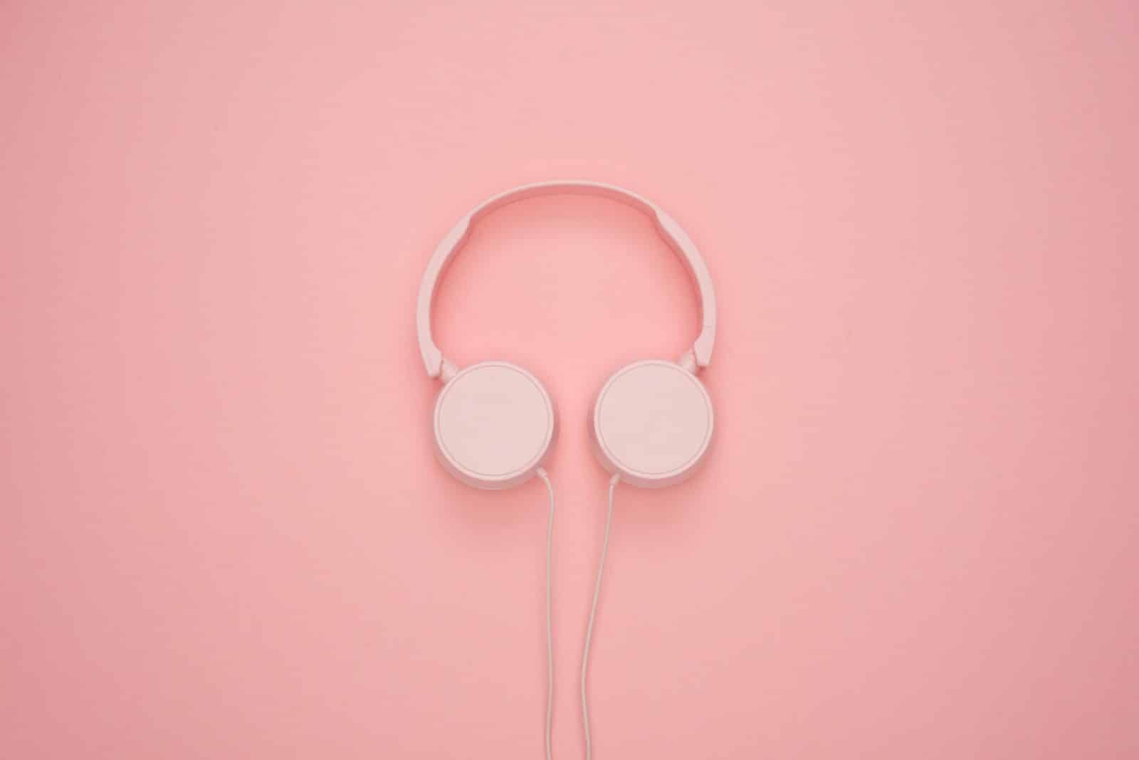 White Headphones On Pastel Pink Background