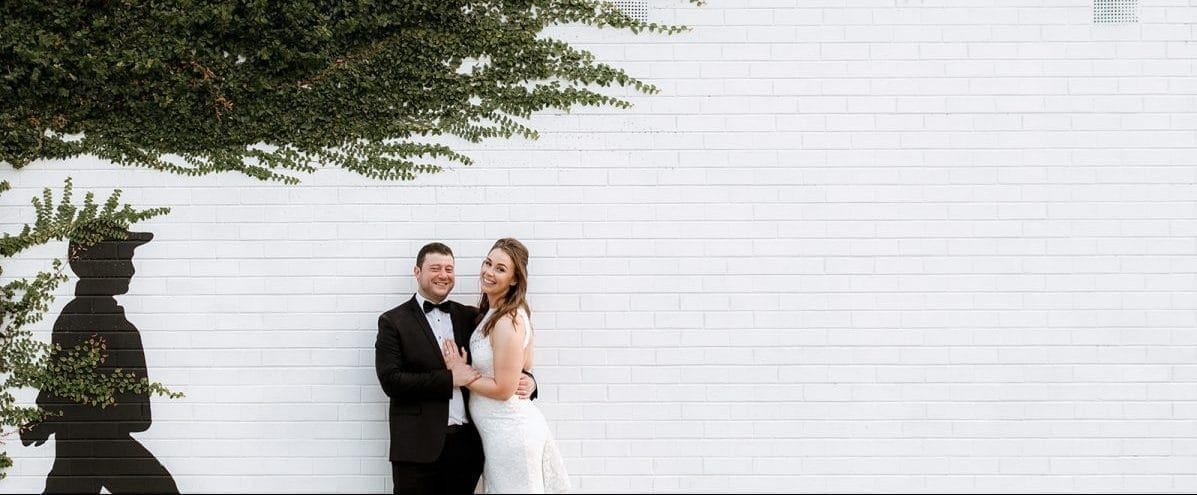 Bride And Groom Pose In Front Of Little Henri Thornbury