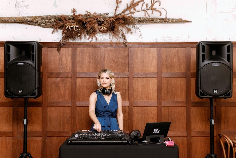 Female DJ Aleks Mac Poses Behind Decks At Little Henri Thornbury Wedding