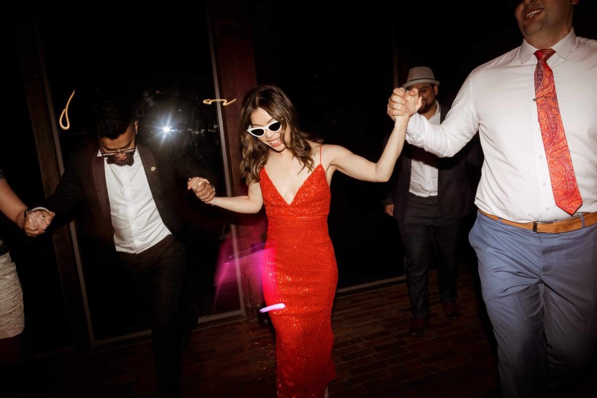 Bride in Red Dress Dancing at Her Jackalope Wedding Photographed By Nikki McCrone